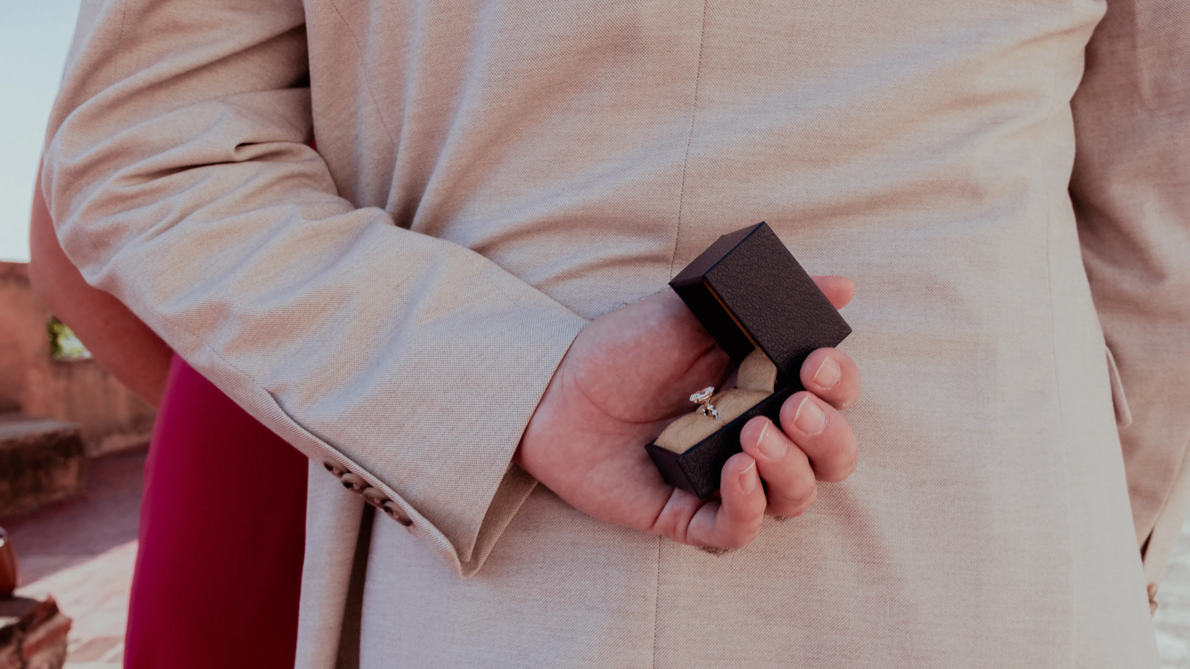 The Ring in the Palm: Proposal Captured Proposal photography in Santo Domingo: hand holding black ring box, trembling hand detail, natural light moment